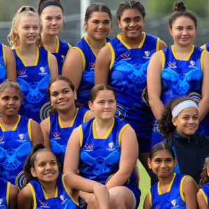 group of teenage girls in football uniforms smiling
